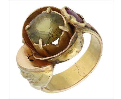 A gem set dress ring by Margaret Barnaby, circa 1970, of abstract naturalistic design, set with a circular-cut chrysoberyl to