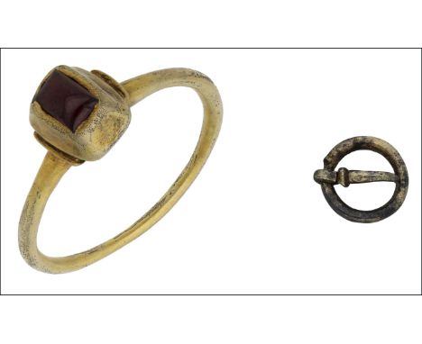 A Medieval silver gilt garnet set ring, 14th century and a Medieval buckle, the ring with rectangular pie-dish bezel, set wit