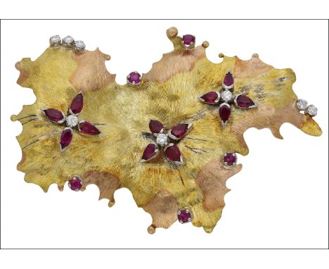 An 18ct gold ruby and diamond brooch, 1966, the bicolour brooch of textured organic design, accented with three flowerheads s
