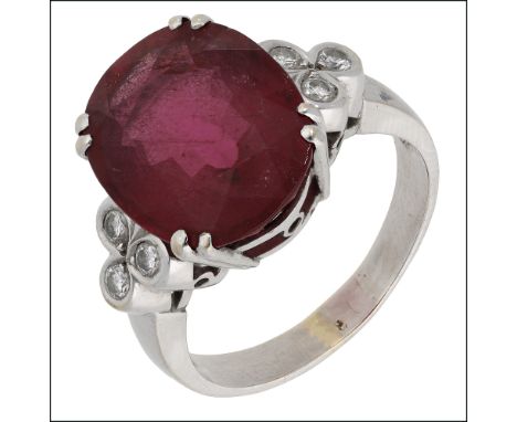 A rubellite and diamond dress ring by Mary Carmen, the oval mixed-cut rubellite in twin claw settings, between diamond set sh