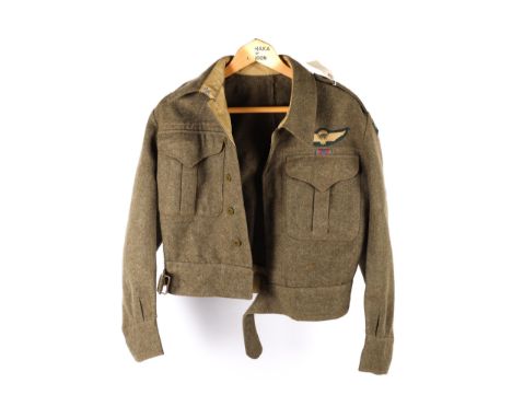 A WWII Canadian khaki battledress blouse, by the Earl Clothing Co, Montreal, 1943 with 2nd Lieutenant pips, parachute wings, 