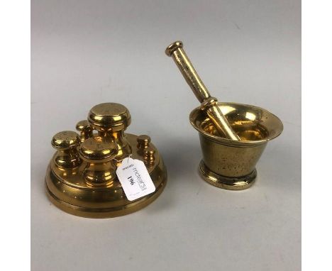 SET OF VICTORIAN BRASS WEIGHTS, inset to a circular stand, 15cm diameter, along with a brass lidded jar, a brass mortar and p