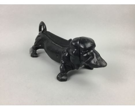 VINTAGE CAST IRON DOORSTOP/BOOTSCRAPER FORMED AS A DASCHUND, painted black, 36cm long