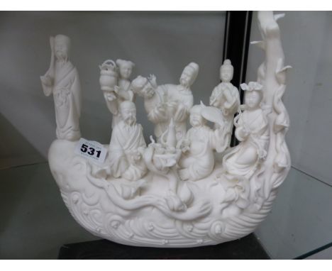 A CHINESE BISCUIT PORCELAIN TREE TRUNK SHIP BEARING THE EIGHT DAOIST IMMORTALS