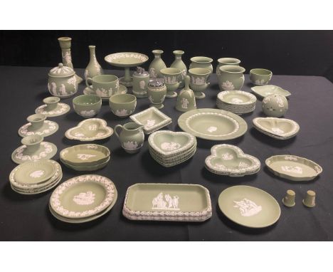 A quantity of Wedgwood green jasperware including vases, preserve jar and cover, comport, candlesticks, table lighters, trink