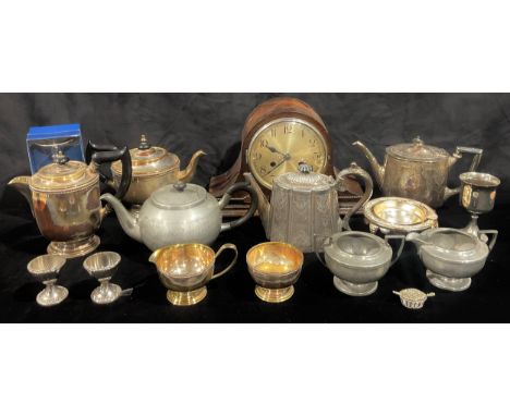 An oak mantel clock, Arabic numerals, twin winding holes, eight day; a pewter three piece tea set; late 19th century EPNS tea