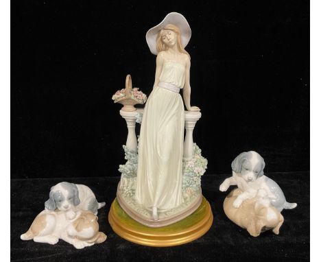 A Lladro figure, Time for Reflection, 5378, 34cm high; a Nao by Lladro model, Puppies Playing; another similar (3) 