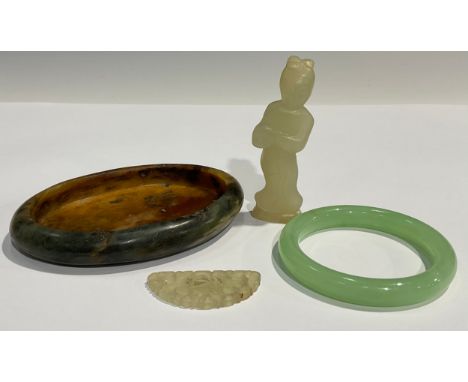 A Chinese oval dish; a jade figure; a bangle; a small carving 