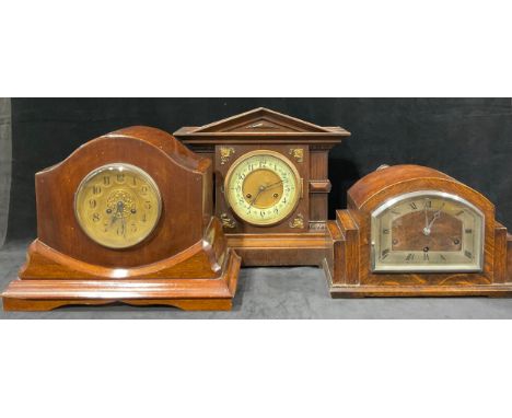 A late 19th century oak architectural mantel clock, arched pediment, the dial flanked by columns, Arabic numerals, twin windi