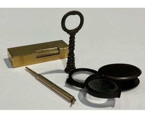 A Dunhill lighter; a miniature pencil; a tortoiseshell eye glass; a Georgian tamper 