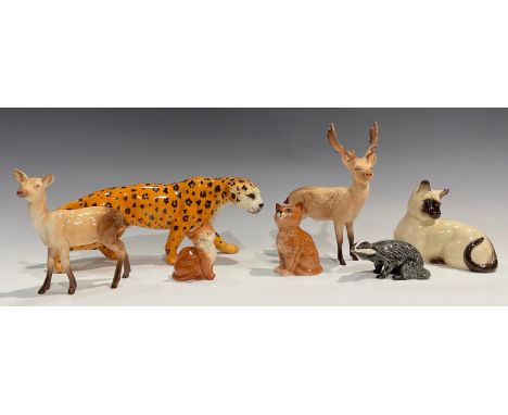 A Beswick model, of a leopard, 29cm long; a Beswick model of a stag, 20.5cm high; another, Doe; others, Badger, Siamese cat; 