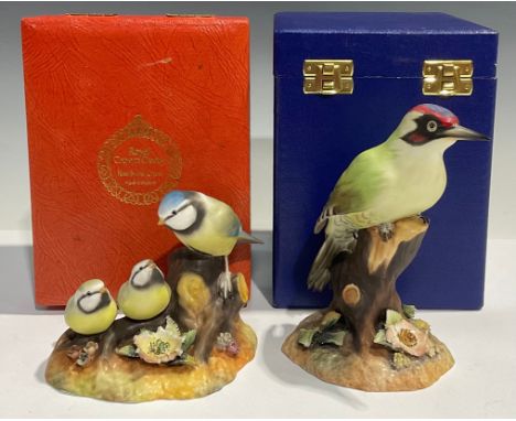 A Royal Crown Derby model, of a Blue Tit and Chicks, cased; another, Green Woodpecker, cased (2) 