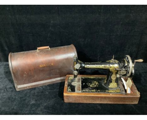 A Singer manual sewing machine, wooden carry case 