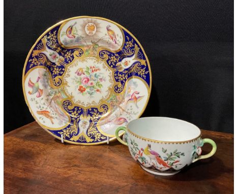 A Continental porcelain plate, probably Sevres, the field painted with flowers in gilt c-scroll cartouche, on a cobalt blue g