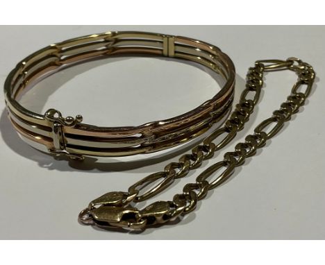 A 9ct tri-gold bangle, marked 375, fastening with a clasp, the interior6cm, 16.2g; a 9ct gold fancy link bracelet, 6.4g (2) 