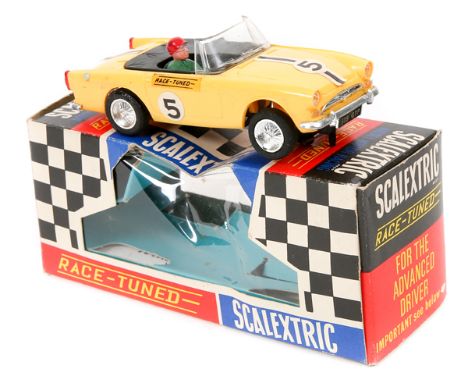 A late 1960’s early 1970’s Scalextric ‘Race Tuned’ series Sunbeam Tiger. (C/83). An example in yellow with black tonneau cove