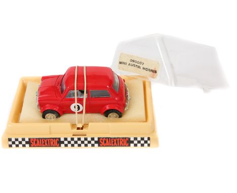 A scarce 1970’s French Scalextric Austin-Morris Mini racing car (090007). In bright red with black interior, RN9. In cream ba