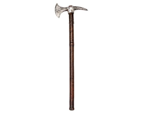 A late 18th century axe head,  blade 5”, curved square section spike, armourer’s mark, with short tangs to a later haft, 34” 
