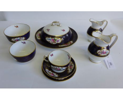 Spode Copelands teawares with blue and gilt ground, decorated with roses, retailed by T. Goode & Co. London