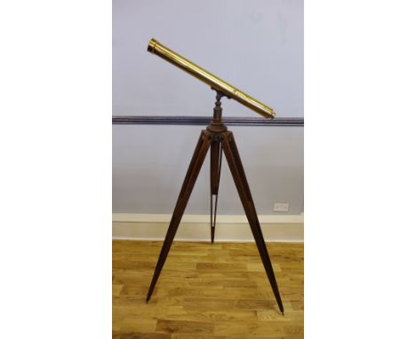 A late 19th Century / early 20th Century brass telescope, having an adjustable wooden tripod stand, complete with extra lens 