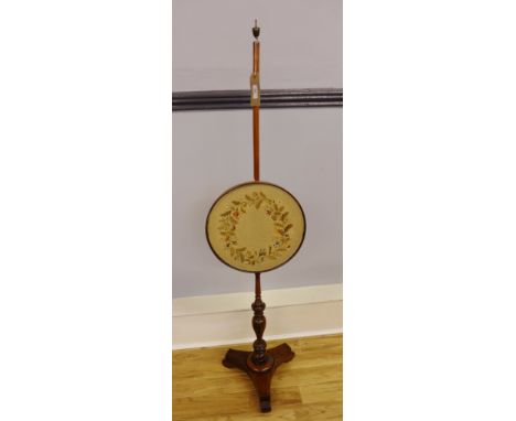 A 19th Century rosewood fire poll, having an adjustable circular embroidered screen, raised on a turned support and moulded f