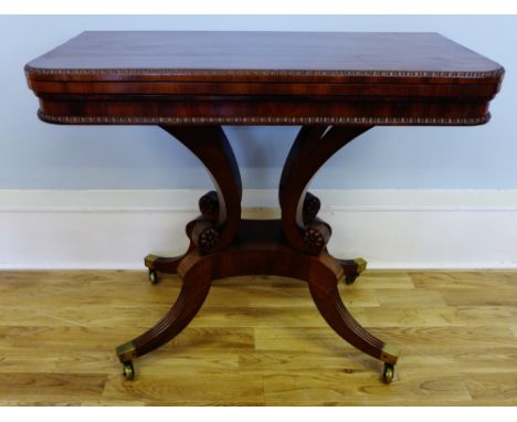 A 19th century mahogany flip top card table having moulded top with carved bead worked edge, raised on splayed fluted support