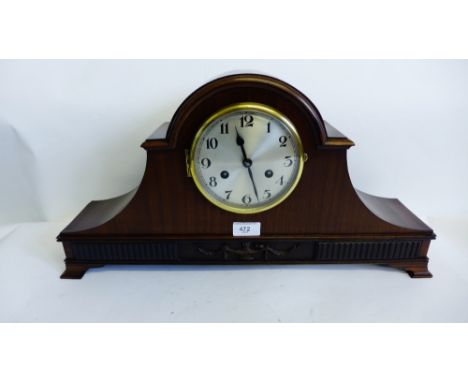 An Edwardian mahogany mantle clock with silvered dial and Arabic numerals, raised on bracket feet, 56 x 30cm 