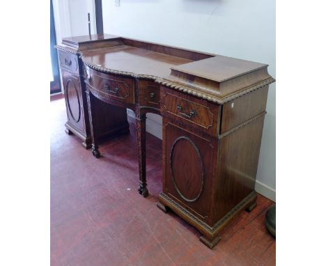 A Victorian breakfront mahogany sideboard having a moulded top over bow fronted central drawer flanked by two small and two s