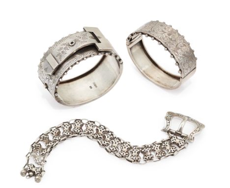 Three sterling silver bracelets,&nbsp;comprising: a Victorian sterling silver hinged bangle of buckle design, with engraved d