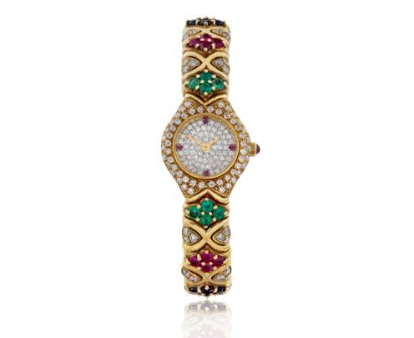 Swiss. An 18ct gold diamond, ruby, emerald and sapphire sprung bangle watch  Circa 1990, Stamped 750 Quartz movement, diamond