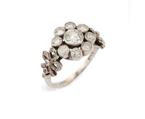 An early 20th century platinum diamond cluster ring, the old European cut diamond with an estimated weight of approximately 0
