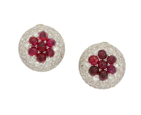 A pair of ruby and diamond cluster earrings, each with cabochon rubies, with pavé-set diamond domed surround, to post and cli