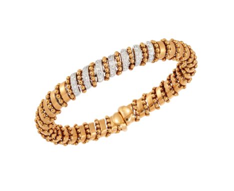 A diamond set semi flexible sprung bangle, with spiralling beaded design, the front with seven rows of brilliant-cut diamonds