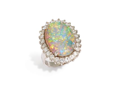 An opal and diamond cluster ring, the oval cabochon opal approximately 19.4 x 13.7mm, within brilliant cut diamond surround, 