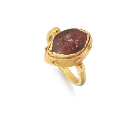A Sasanian carnelian intaglio in later ring mount, the navette shaped intaglio engraved as a stag, in later collet mount with