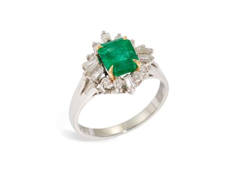 An emerald and diamond cluster ring, composed of a central rectangular-cut emerald, measuring approximately 6.4 x 5.7 x 4.2mm