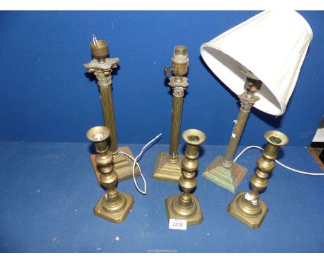 Three small Victorian brass candlesticks, diamond sided, pair of small Corinthian column table lamp bases and larger Corinthi