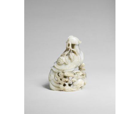 A PALE GREEN JADE 'PHOENIX AND PEONY' GROUP17th/18th centuryCarved and pierced as a craggy rock, on one facet a phoenix with 