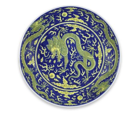 A BLUE AND YELLOW 'DRAGON' SAUCER-DISHQianlong six-character seal mark and of the periodWell potted with a lipped rim, intric