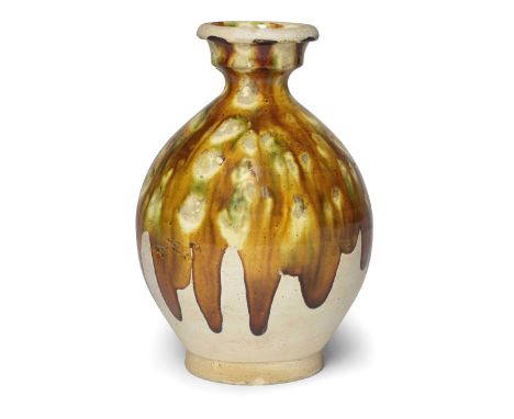 A SANCAI-GLAZED BOTTLE VASETang DynastyThe ovoid body rising from a spreading foot to a waisted neck with a cup-shaped mouth,