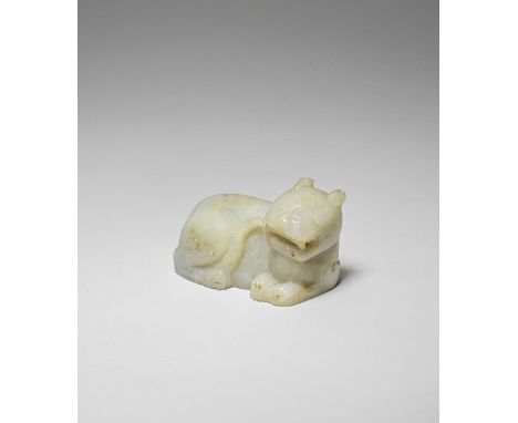 A PALE GREEN JADE CARVING OF A TIGERSong/Yuan Dynasty or laterCrisply carved, the large recumbent feline turned sharply to th