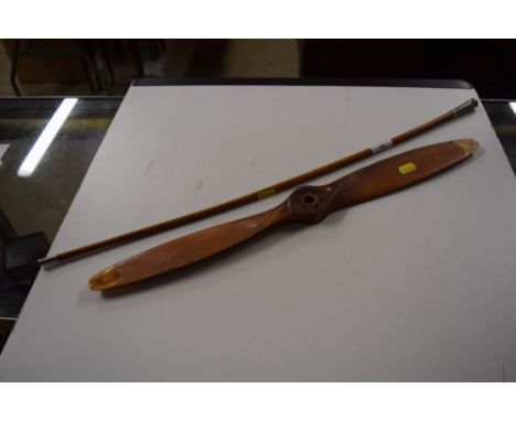 A vintage aircraft generator propeller ? with a WW1 army swagger stick 