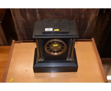 A late Victorian black slate two hole mantel clock