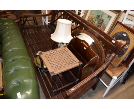 An oak framed and bevelled edge mirror; a magazine rack; a string top stool; a table lamp and a Victorian brass and copper wa