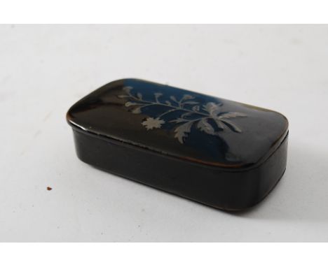 A 19th cenutry papier mache snuff box with inlaid detailing to the lid, the box of lozenge shape form