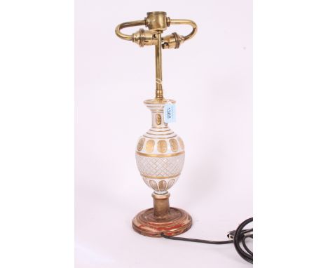 A 19th century Bohemian glass and brass table lamp. The wooden gilded base with fabulous white overlay bulbous glass centre h