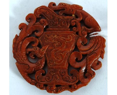 A carved Jade roundel having fret pierced centre of scroll work and dragons