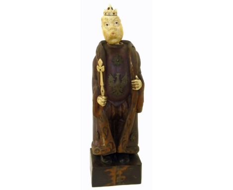 An early 20th Century German carved wood and ivory automaton, modelled as a humorous Germanic baron with long robe, applied b