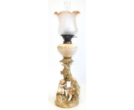 Royal Worcester oil lamp with two figures of children sat at the base We are unable to do condition reports on our Interiors 