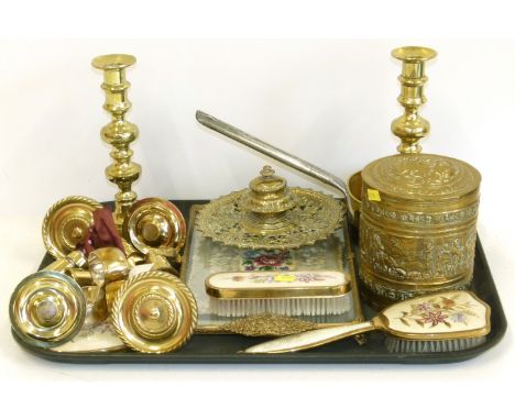A collection of brass to include a pair of candlesticks, saucepan, pierced inkwell, 4 castors, embossed brass tobacco jar and